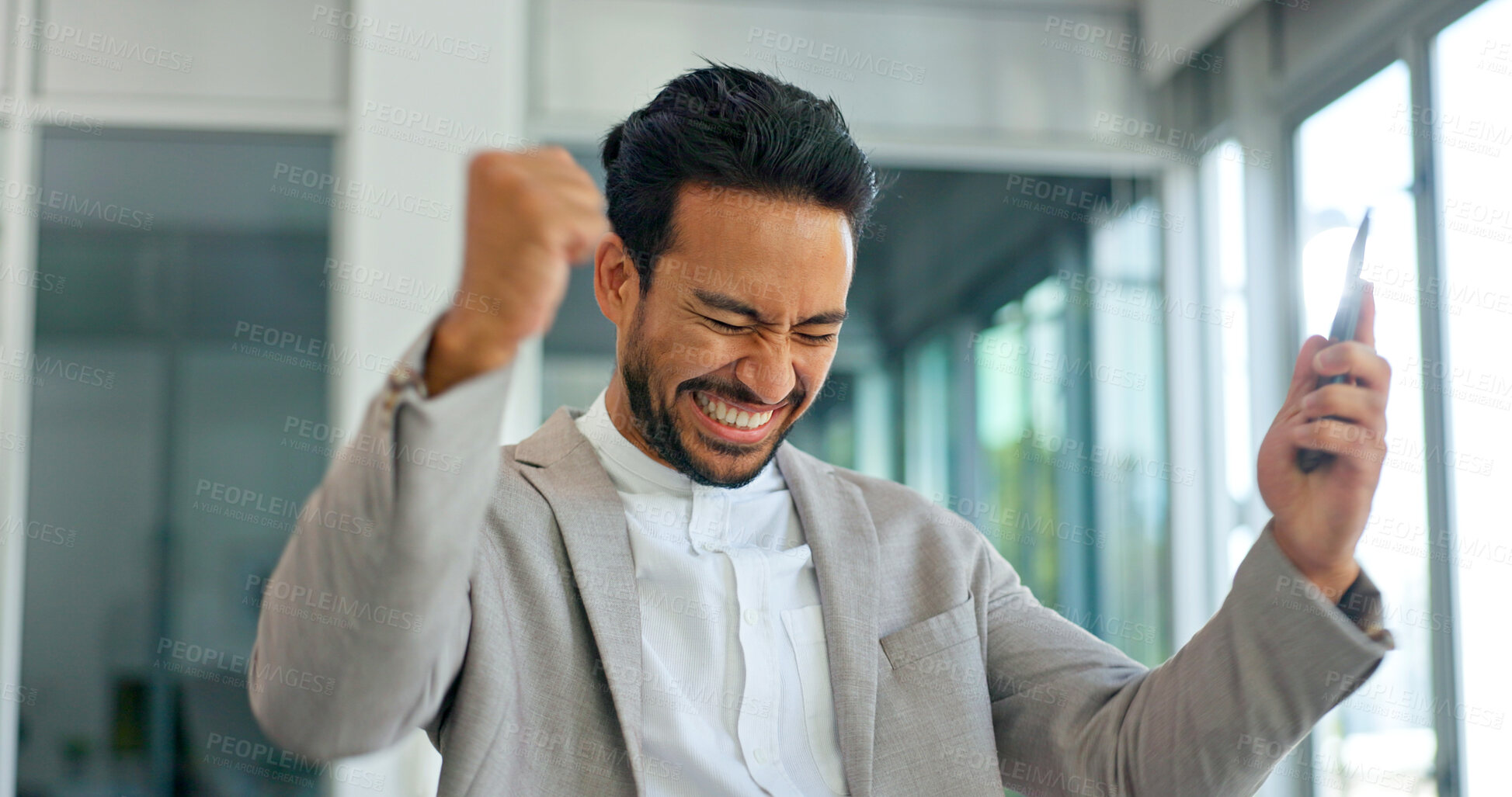 Buy stock photo Celebrate, excited and phone of business man in office for good news or yes feedback. Success, winning and fist of asian male employee with smartphone for wow achievement, promotion or online bonus