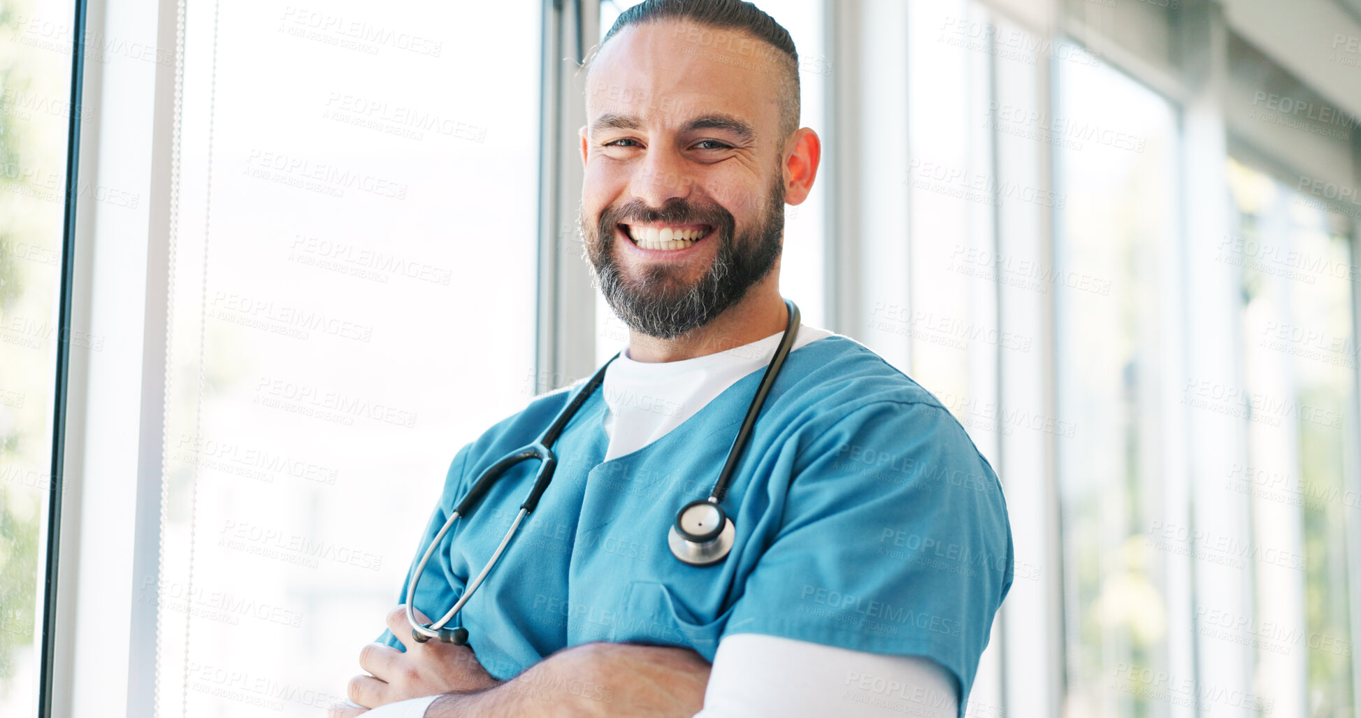 Buy stock photo Doctor in portrait, man with arms crossed and healthcare, smile with confidence at hospital with pride and help. Happy medical professional, trust and expert at clinic with scrubs and medicine