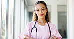 Face, doctor and black woman with smile, healthcare and wellness in hospital, arms crossed and confident. Portrait, African American female and medical professional in uniform, happy and leadership