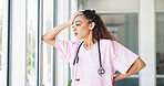 Doctor, woman and stress by window with headache, burnout or sad in hospital workplace with hand on head. Black woman, healthcare medic and mental health problem at clinic job with anxiety in Atlanta