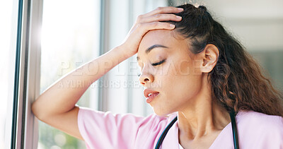 Nurse, thinking or stress headache by window in hospital, clinic or wellness theater and mental health burnout or anxiety. Exhausted, fatigue or tired healthcare woman in surgery mistake or work risk
