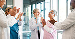 Doctor, nurse and team applause in celebration for healthcare achievement, goal or promotion at hospital. Group of medical professional clapping and celebrating teamwork, unity or victory at clinic