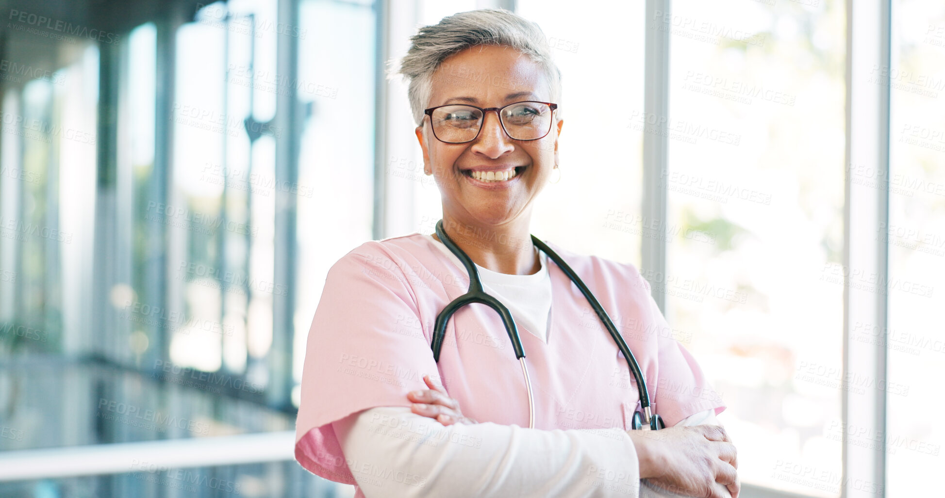 Buy stock photo Mature nurse, portrait and arms crossed in hospital with healthcare, service or care with expert, surgeon and clinic. Happy, face and woman doctor with smile or pride in medicine, wellness and career