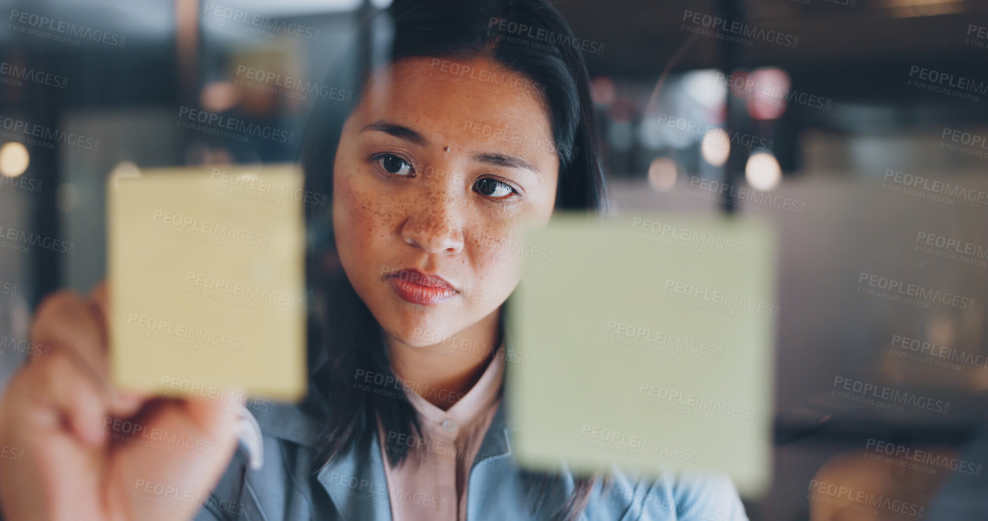 Buy stock photo Night, sticky notes and business woman writing in office for schedule, calendar or creative idea. Agenda, strategy and face of Asian female designer with visual, thinking or kpi solution and planning