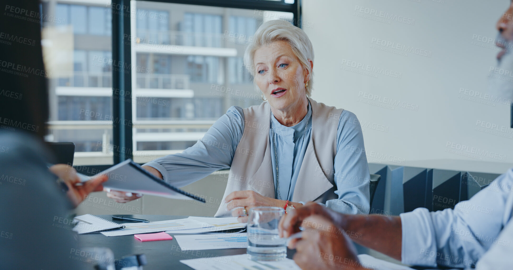 Buy stock photo Senior woman, leader and teamwork with planning, meeting and conversation with collaboration, brainstorming and paperwork. Mature person, staff and group with documents, support and cooperation