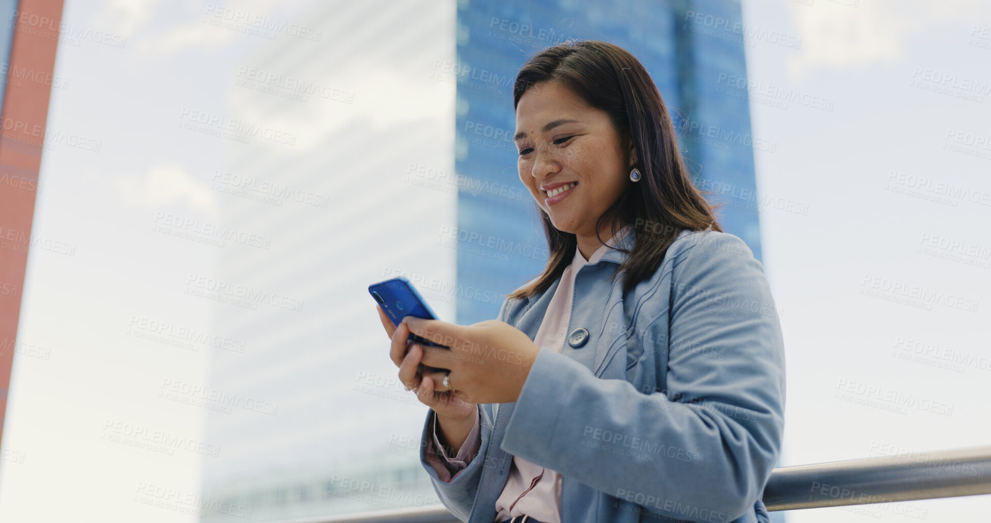 Buy stock photo Phone, networking and Asian businesswoman in the city walking to work typing a corporate email. Happy, smile and young Japanese female lawyer scroll on cellphone commuting in an urban town street.