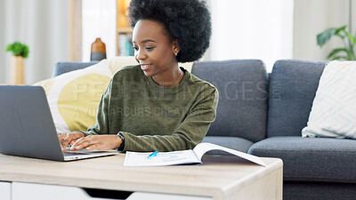 Female student studying using laptop and making notes to prepare for exams or research for college assignment. African woman highlighting information while learning and doing online course from home