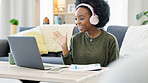 Woman talking on videocall using laptop and headphones while waving hello to friends online. Student making notes while communicating and learning new language during online course or private lesson