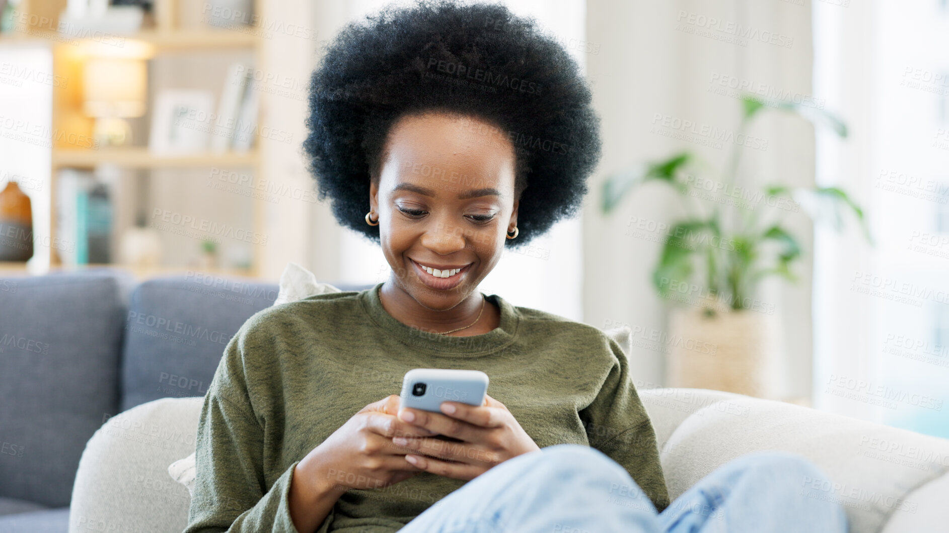 Buy stock photo Phone, black woman and typing on sofa in home, reading social media notification and update subscription app. Smile, smartphone and download mobile games, search digital network and online contact 