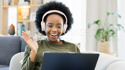 African woman using laptop and headphones while waving hello during a video call with friends. Student talking to her teacher and learning new language online during online course or private lesson