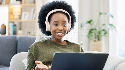 African woman using laptop and headphones while waving hello during a video call with friends. Student talking to her teacher and learning new language online during online course or private lesson