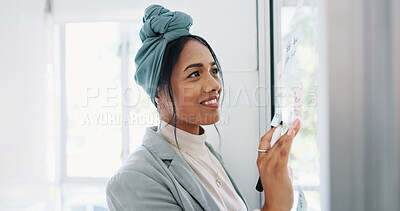 Business woman, writing and brainstorming idea with glass board and post it, happy with focus and planning strategy for project. Corporate employee, marketing strategy or project management goals.