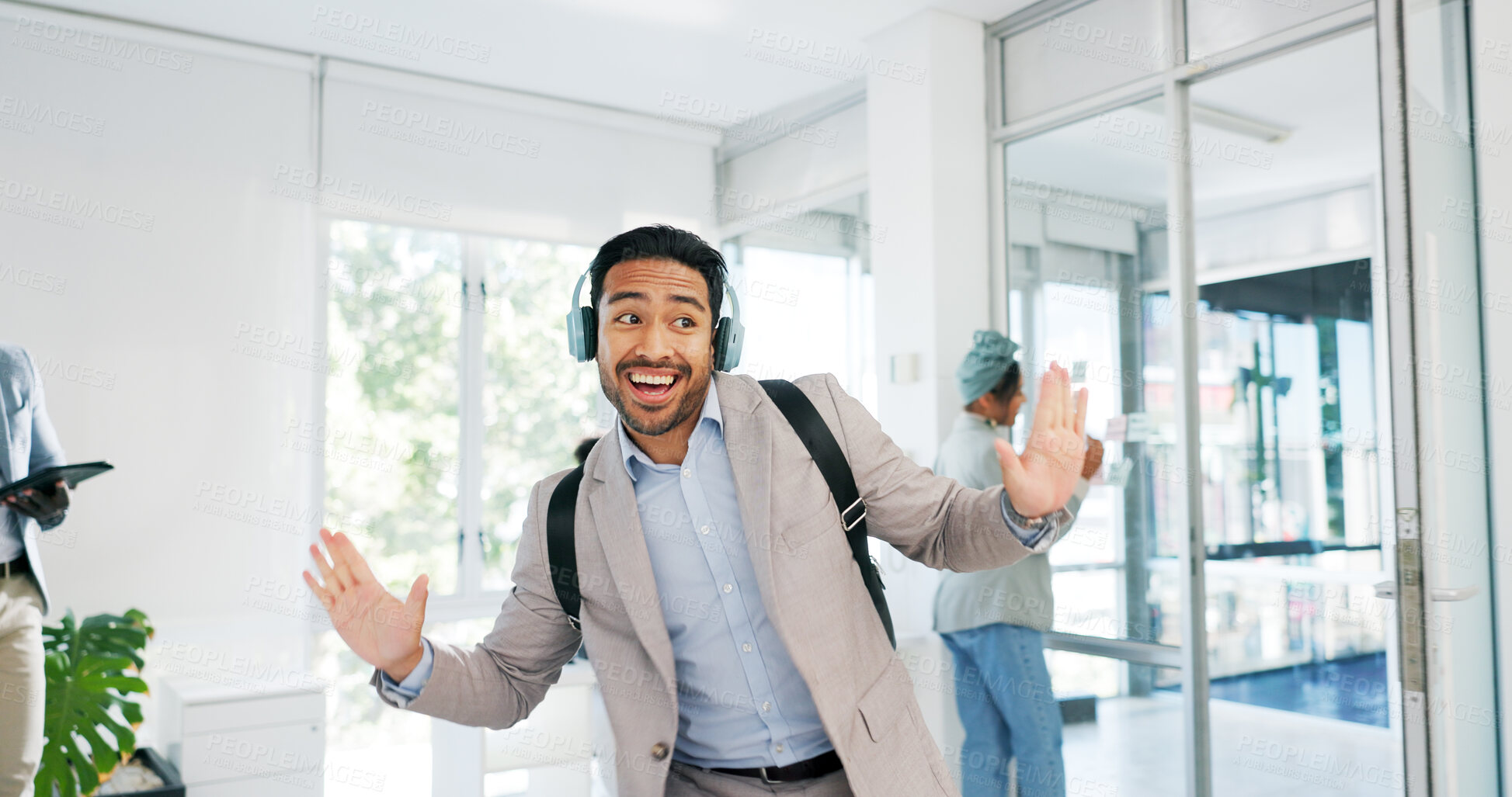 Buy stock photo Music, dance and motivation with a business man walking into an office while feeling positive. Success, happy or smile and a confident young employee arriving at work in headphones with a smile