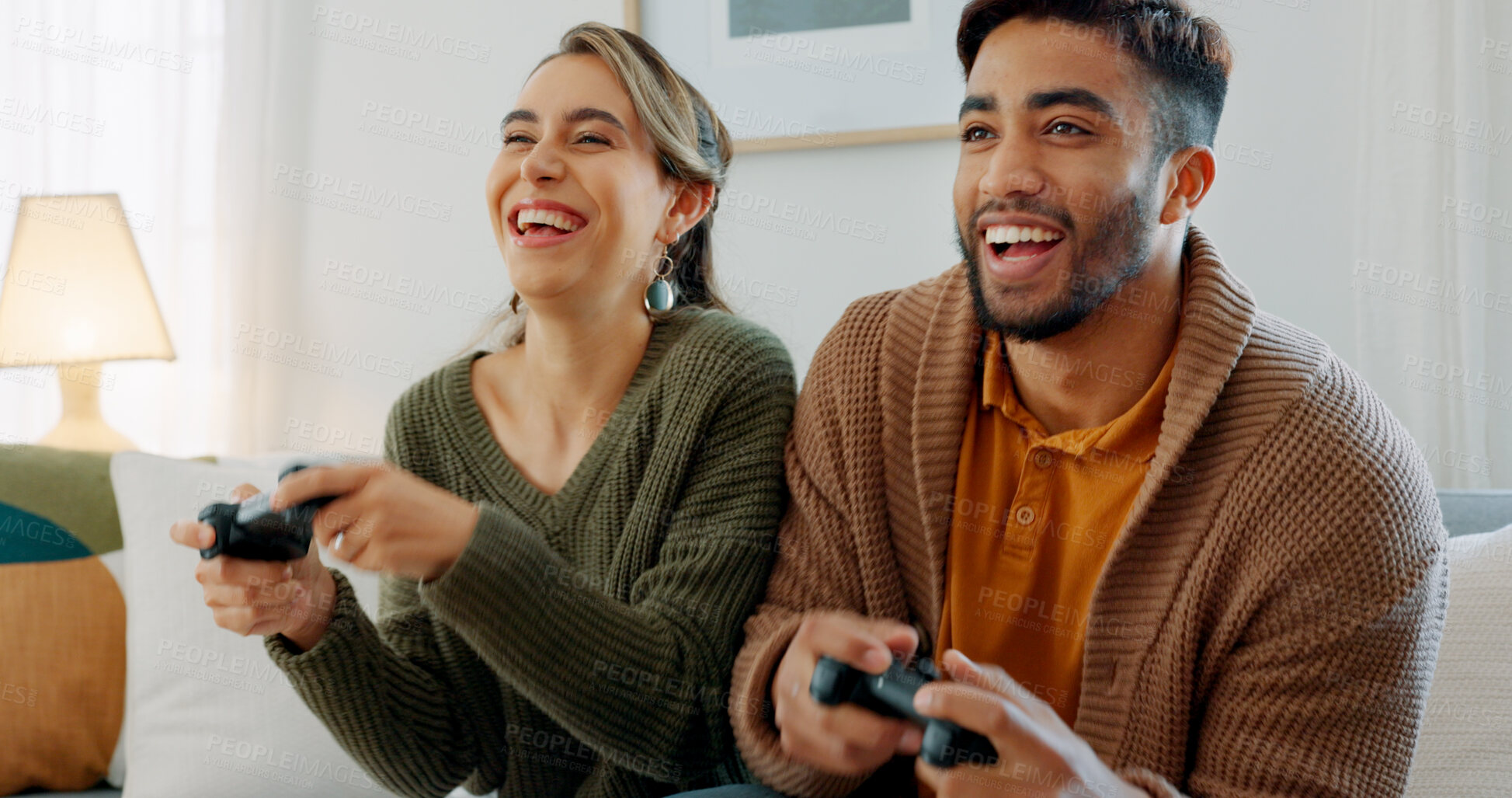 Buy stock photo Home, smile and couple with video game, excited and fun with energy, happiness and bonding. People, man and woman on a couch, playing online and competition with controller, entertainment and love