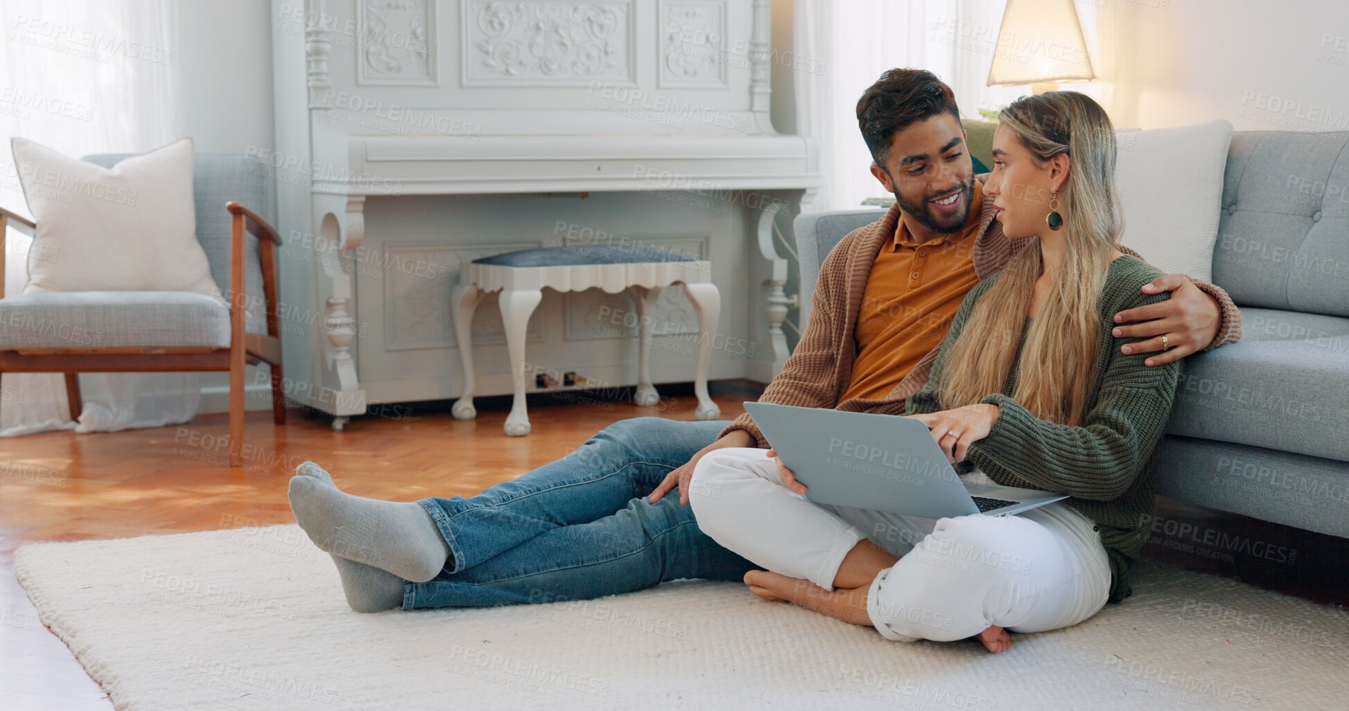 Buy stock photo Interracial couple, laptop and love being happy together for connection, planning date and talking on home floor. Living room, man and woman for bonding, internet and relax with a pc and conversation