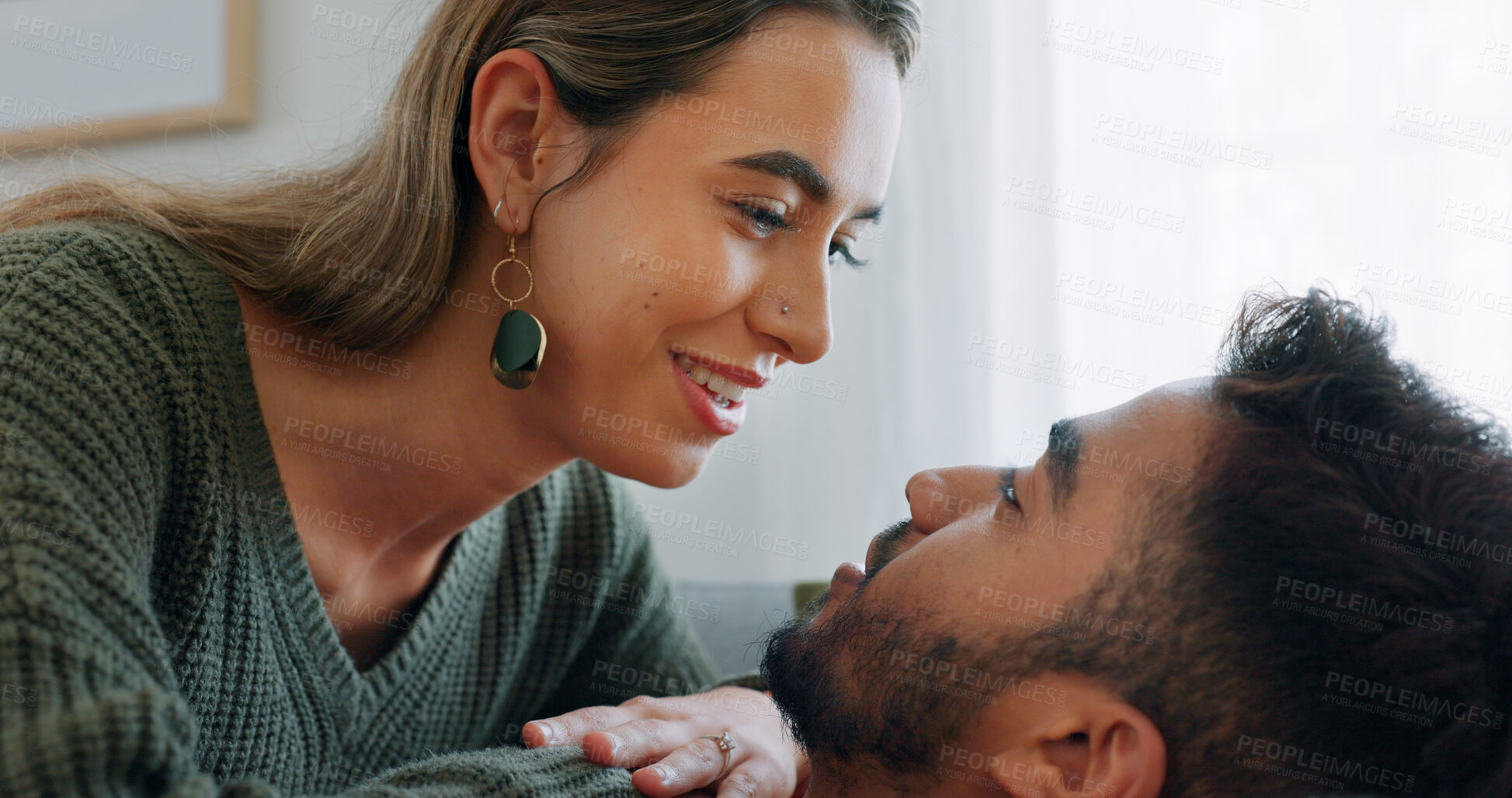 Buy stock photo Interracial, couple and relax with love in home and bonding, time and morning embrace with chat or communication, People, talking and romantic closeup of man and woman with smile in hug or cuddle