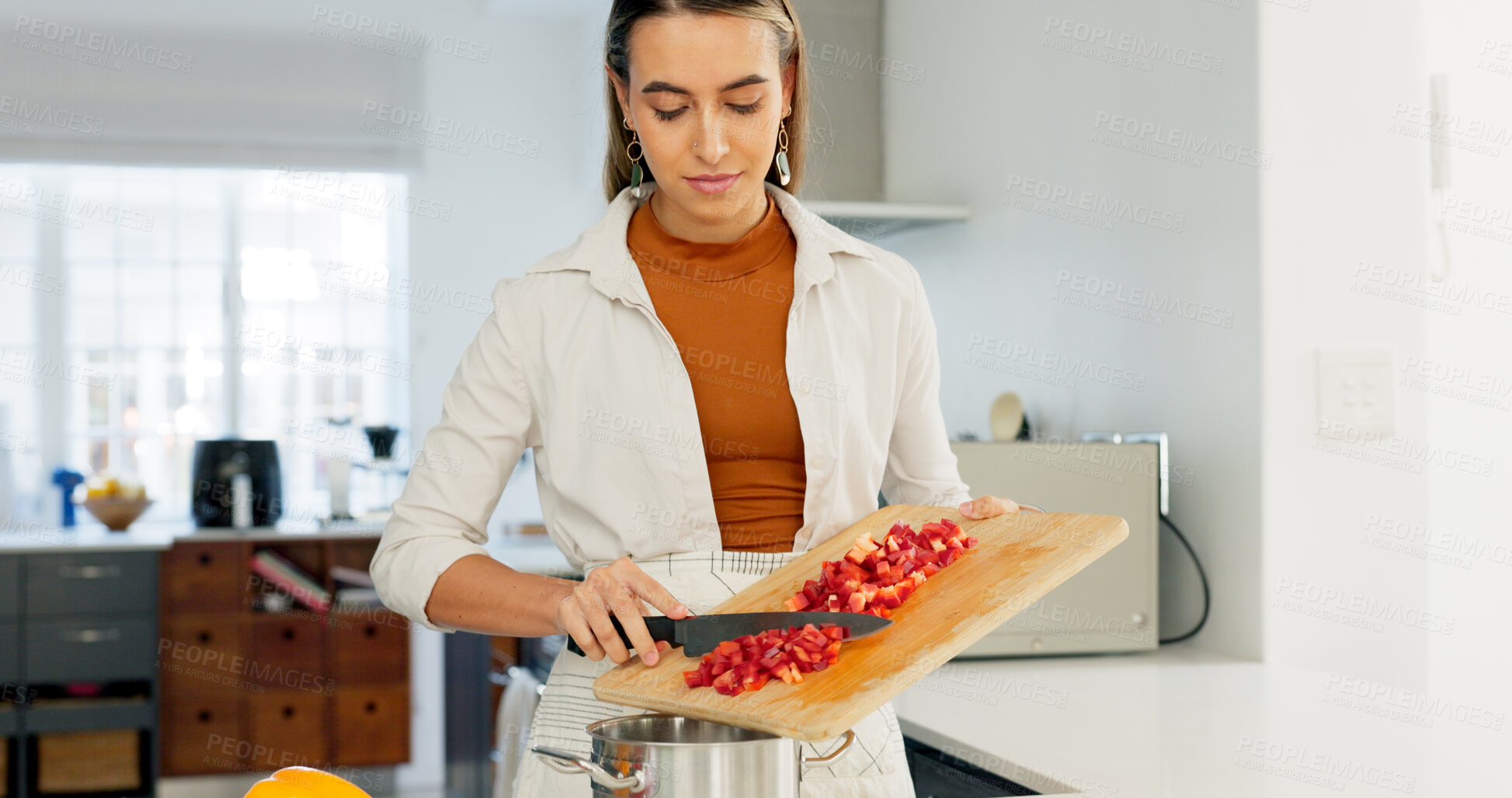 Buy stock photo Woman, cooking vegetables and knife in kitchen, home and thinking with recipe, care and idea by pot. Chef, vegan nutrition and prepare food with tomatoes, pepper or healthy choice for diet in house