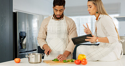 Couple, digital tablet and cooking with online recipe on the kitchen. Young man cutting vegetables and woman reading instructions on the internet, web or food website. while preparing healthy meal