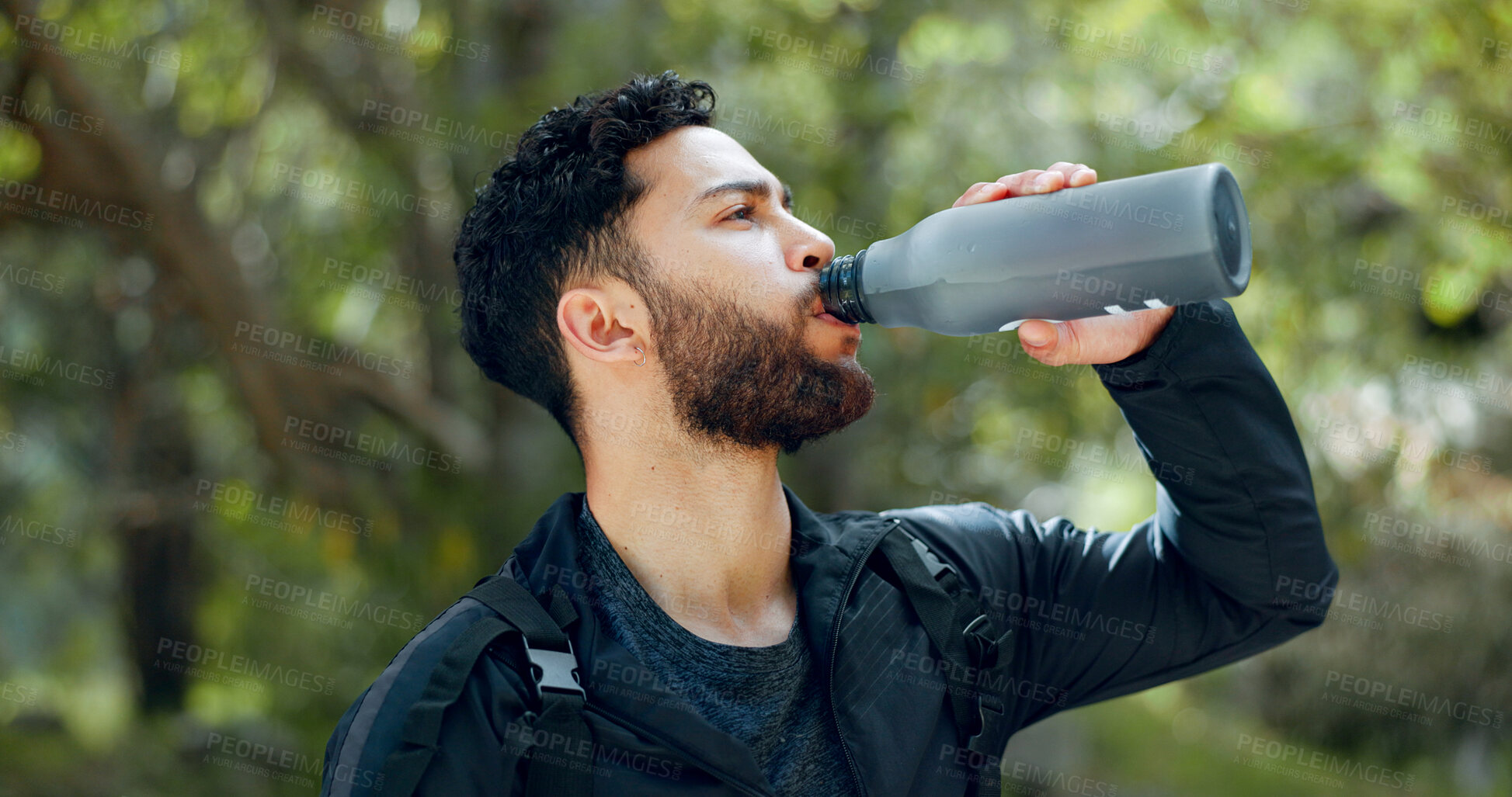 Buy stock photo Man, drinking water and hiking in a forest, nature or woods outdoors for adventure with freedom in Costa Rica. Healthy, fitness and thirsty hiker trekking or walking on a journey refreshing on break