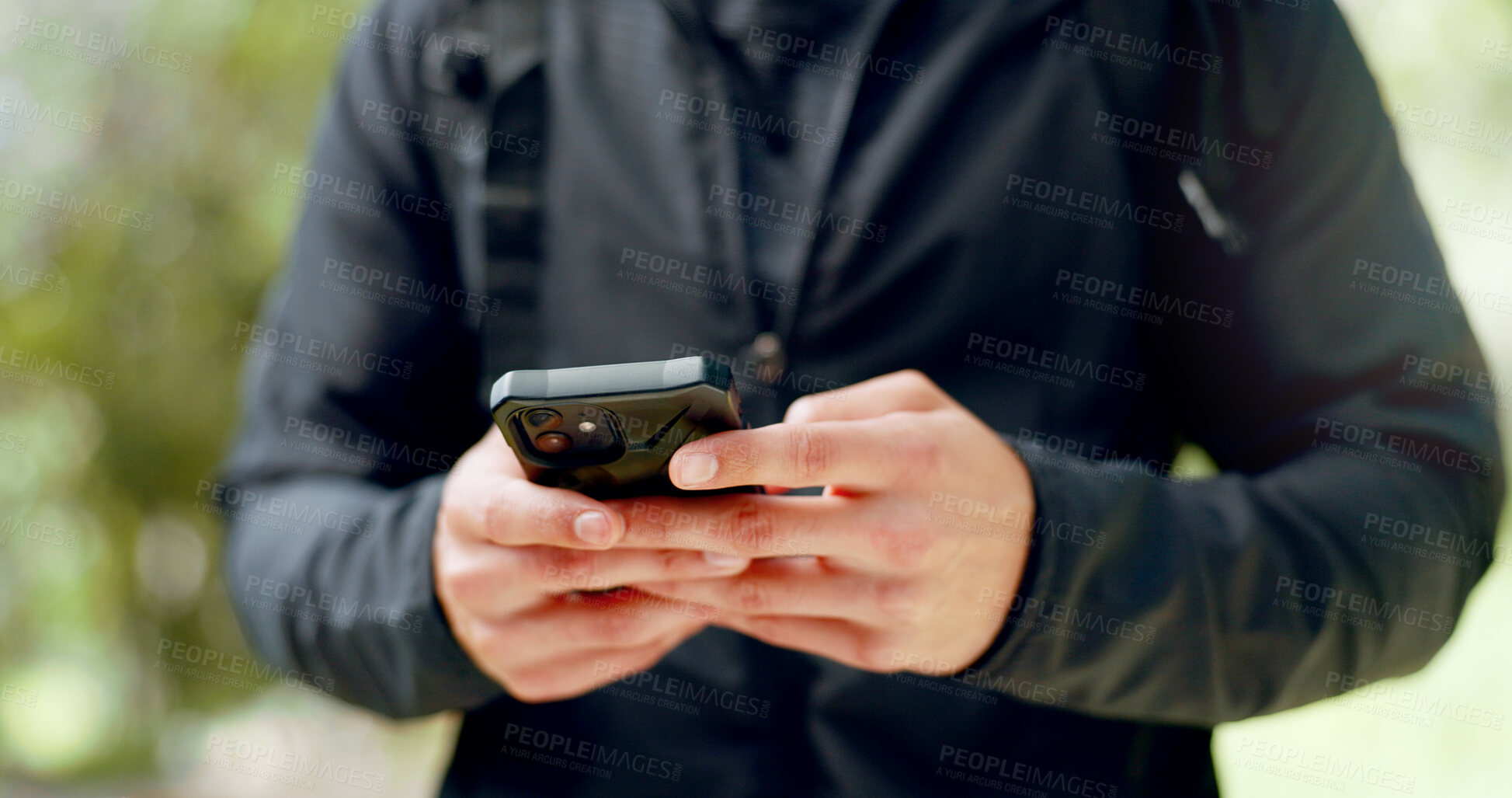 Buy stock photo Man, hands and phone in closeup, typing and hiking in nature, fitness and backpack for adventure. Hiker, nature and social media for tracking progress, workout and health in park, digital and tech