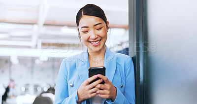 Business woman, phone and typing in office on social media, internet browsing or texting. Tech, mobile and happy female from Japan on break with smartphone for messaging, web scrolling or networking.
