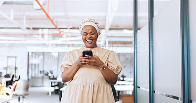 Black woman, phone and communication with a business contact while walking in a creative office laughing about funny meme notification. Happy african employee using mobile data on social network