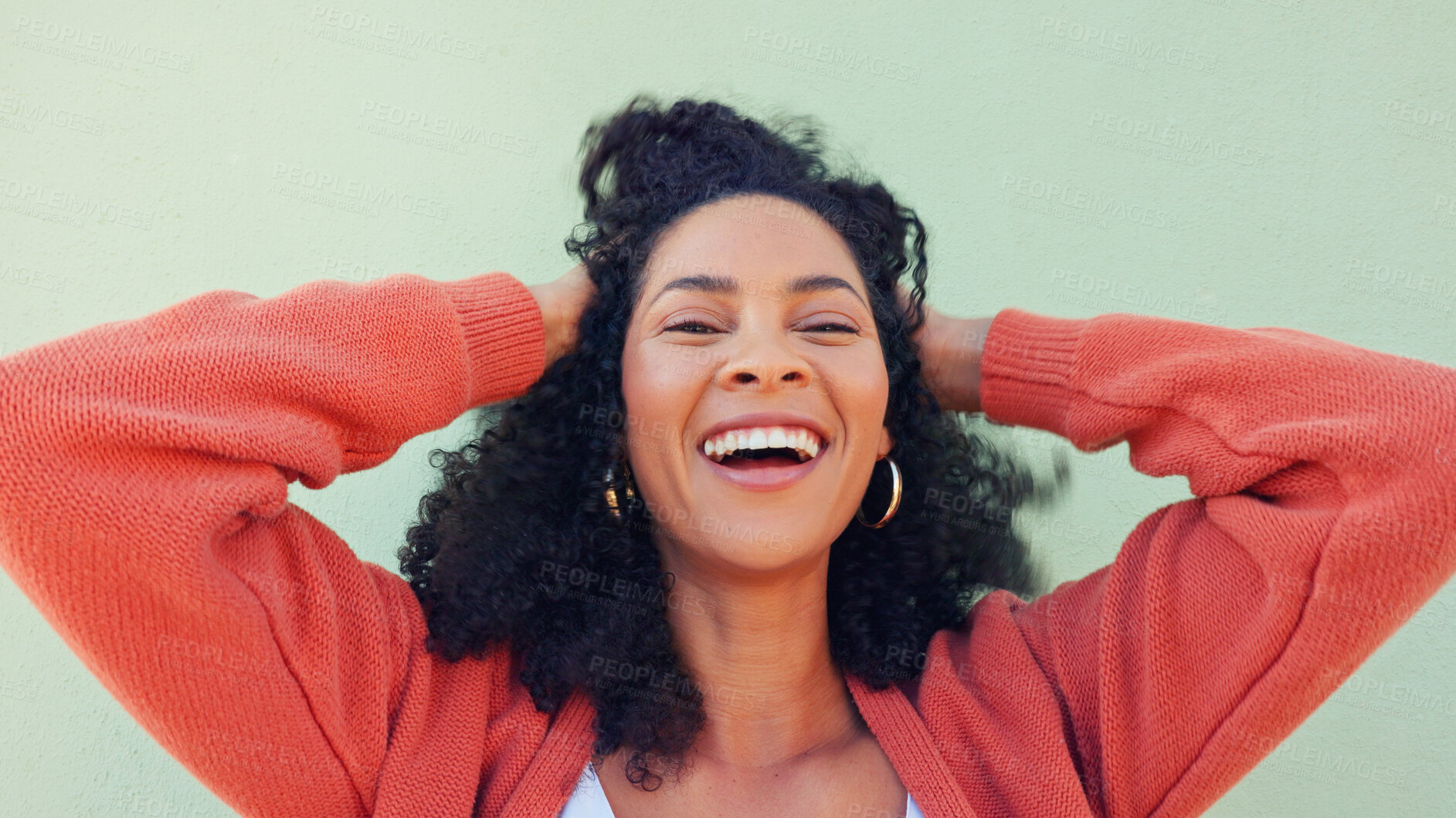 Buy stock photo Woman, portrait and happy with hair or play at wall for beauty or energy, curly treatment or wellness. Black person, natural, and smile for cosmetic care or hands in excitement for healthy results