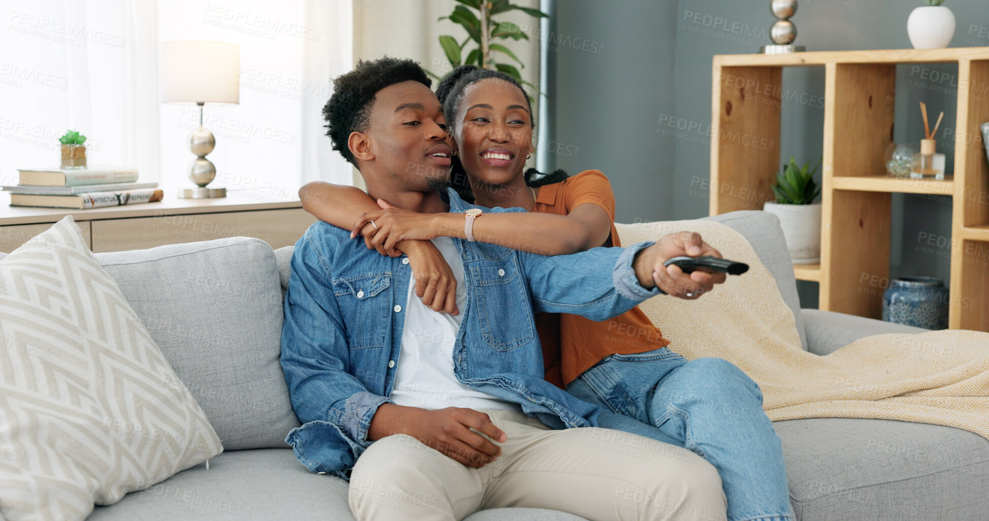 Buy stock photo African couple, relax and watching tv on sofa, home or lounge for movies, streaming subscription or happy for hug. Man, woman and television on sofa in living room with smile, film and video in house