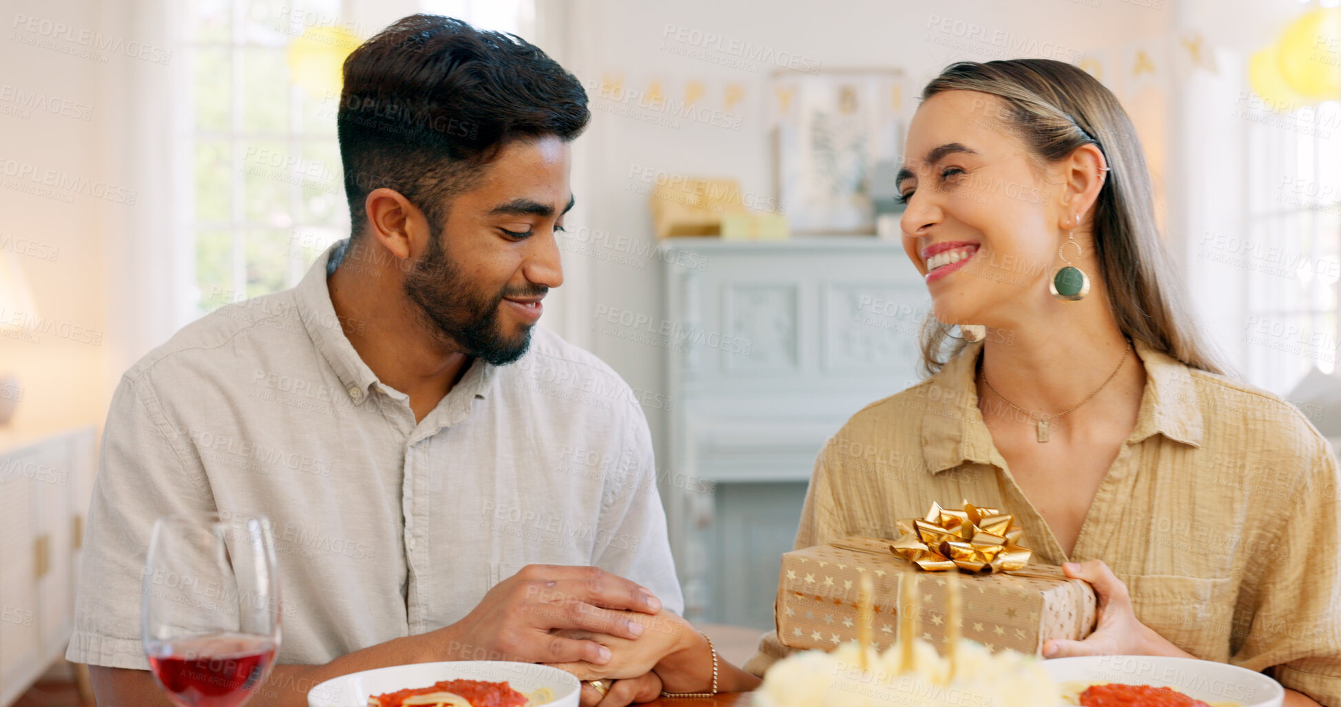 Buy stock photo Birthday, celebration and gift with couple, love and date together in home living room with drink. Happy, smile and people at table with present and dessert with alcohol in a house with smile