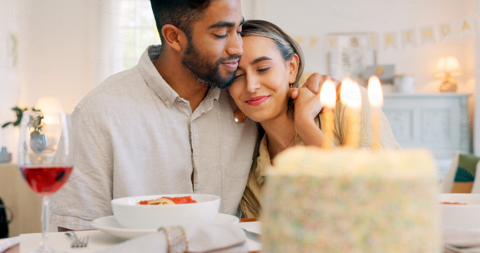 Buy stock photo Birthday cake, celebration hug and food with couple, love and date together in home living room with drink. Happy, smile and people at table with conversation and dessert with alcohol and candles