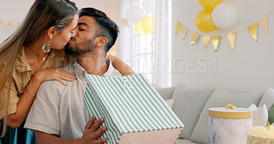 Surprise gift, present bag and happy couple for birthday celebration in home living room with love, kiss and excited. Girlfriend giving box for birthday party together for date, discount and commerce