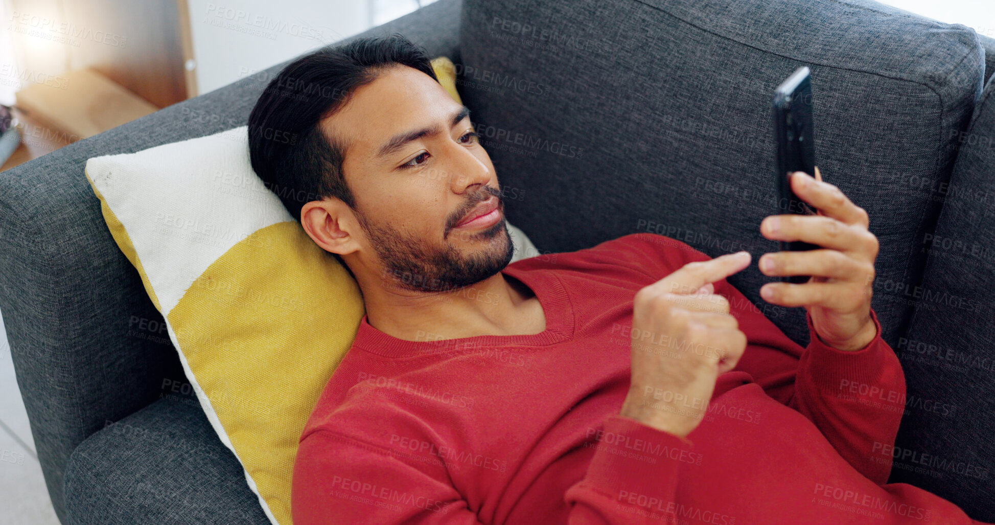 Buy stock photo Phone, search and asian man on a sofa relax with social media, text or streaming service at home. Smartphone, app and Japanese guy in living room for blog, news or reading post or chat communication 