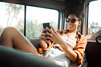 Black woman, phone and road trip in van vacation, holiday or summer trip. Relax, travel and female from Brazil on mobile, social media or text message while spending quality time alone in car