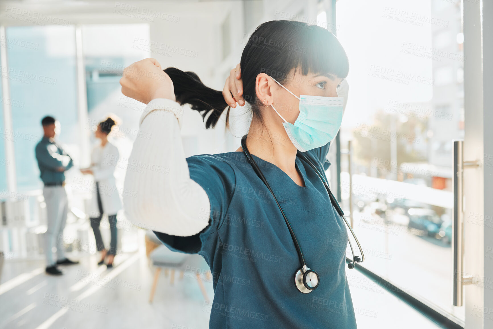 Buy stock photo Covid, window and doctor at a hospital for healthcare, medical work and thinking. Idea, hair care and nurse wearing a face mask for a virus while working at a clinic, looking at view and medicare