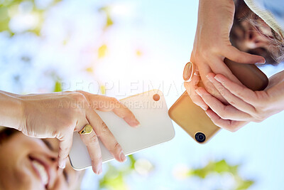 Buy stock photo Hands, bottom view or girl friends with phone in park with smile for online meme, reading comic blog or social media. Typing or women on 5g smartphone for networking, sharing or transfer in outdoors