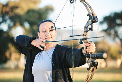 Archery, bow or arrows aim in sports field, shooting range or gaming ground for hunting, hobby or performance exercise. Person, woman or athlete and weapon in target training, competition or practice