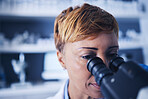 Science, research and woman scientist looking in a microscope to examine for experiment in a lab or laboratory. Doctor, medical and female technician doing sample analysis  for biotechnology