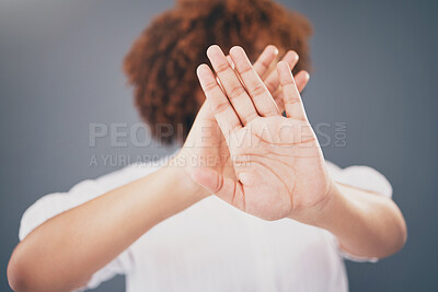 Buy stock photo Closeup, hands and woman in studio for stop, warning or domestic violence symbol on grey background. Zoom, justice and hand of girl in protest, caution and protection, scared and abuse awareness