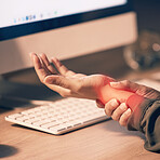 Woman, hands and wrist pain by computer from carpal tunnel syndrome or overworking at night by office desk. Hand of female holding painful arm area or preassure by PC from working late at workplace