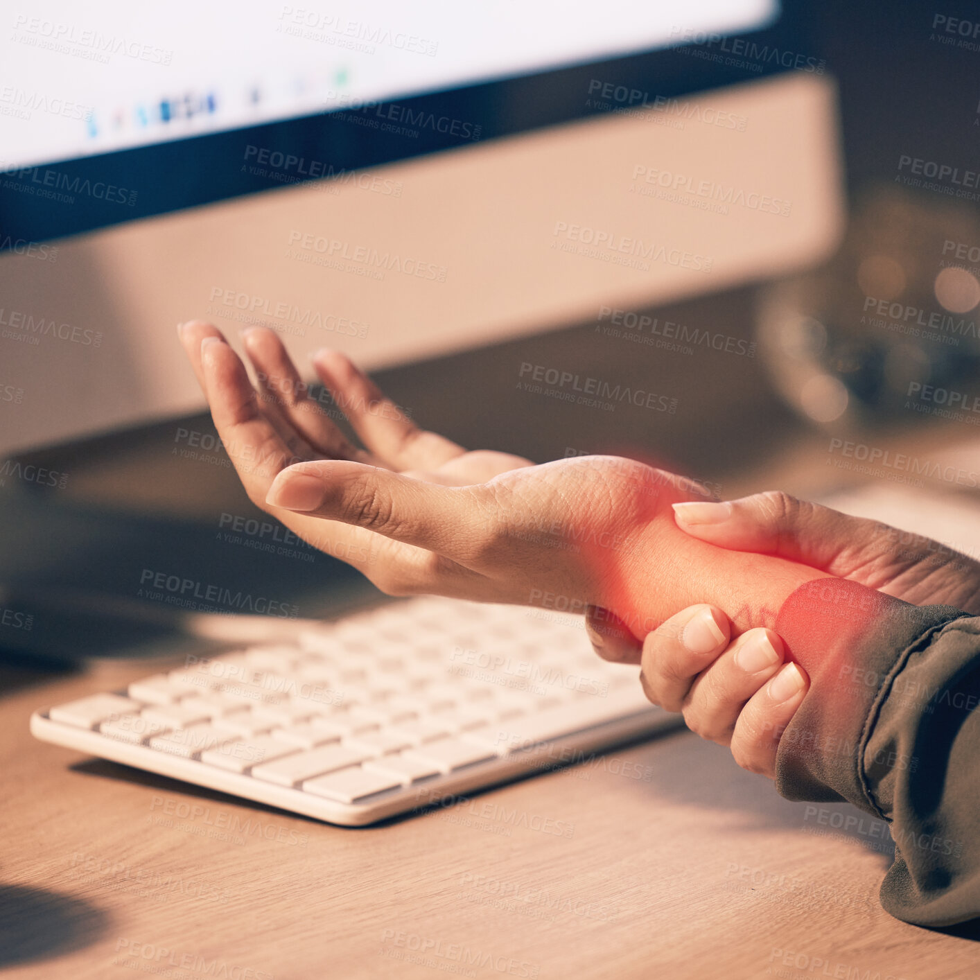 Buy stock photo Woman, hands and wrist pain by computer from carpal tunnel syndrome or overworking at night by office desk. Hand of female holding painful arm area or pressure by PC from working late at workplace
