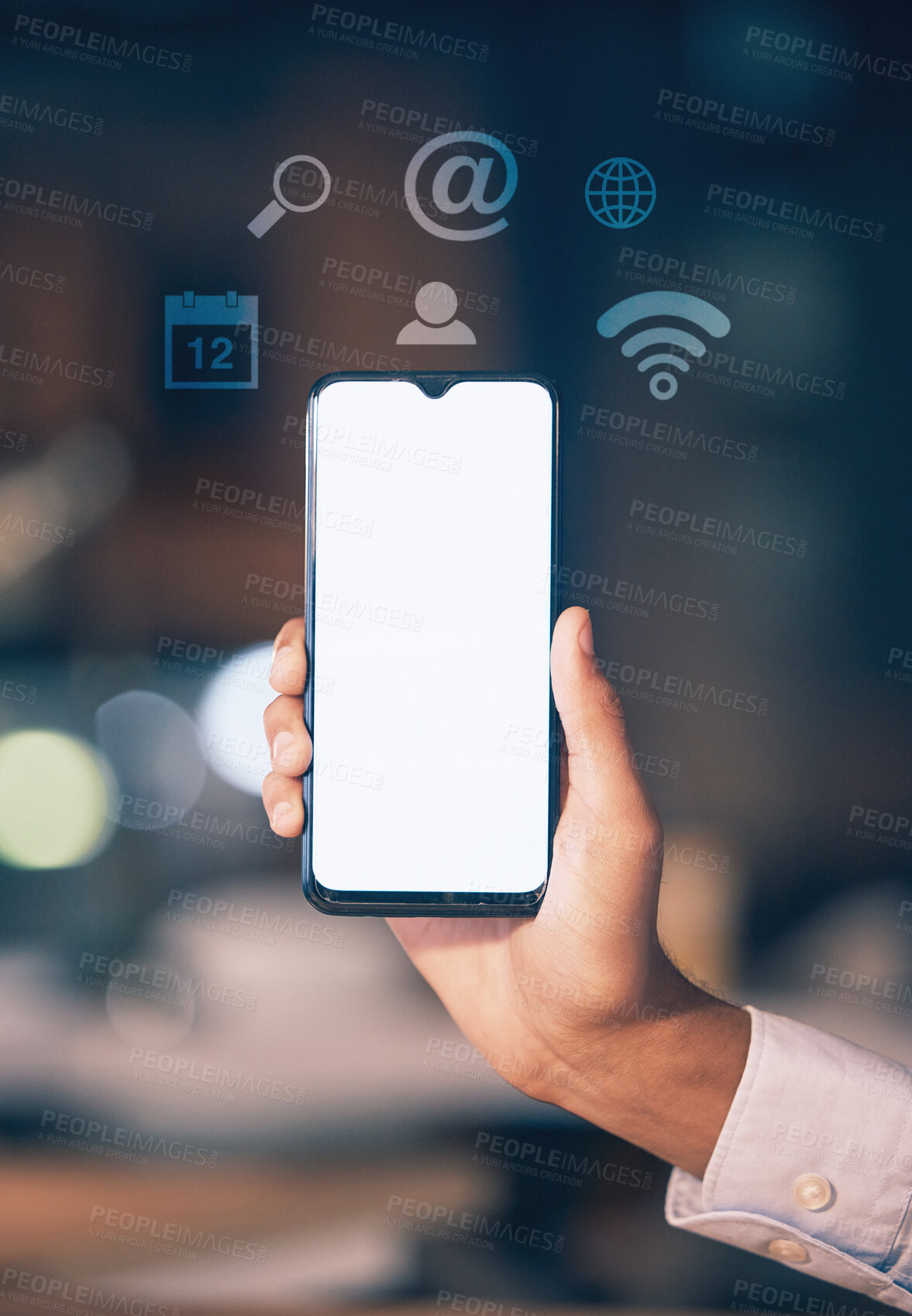 Buy stock photo Hands, phone and mockup screen with icons at night for networking, social media or communication at the office. Hand of employee showing smartphone display for mobile app, branding or multimedia