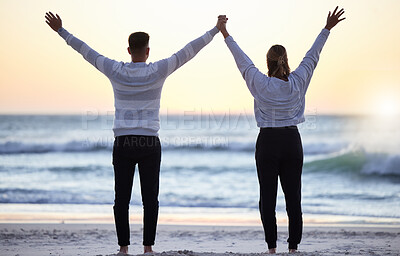 Buy stock photo Couple at beach with hands up, freedom and travel, ocean waves and view, love and adventure together. Relationship, carefree and peace with man and woman with arms in air, back and sunrise in Bali