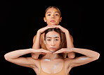 Art, ballet and portrait of women in a studio posing with artistic metallic paint on their body. Creative, artist and female dancers or ballerinas with a glow for dancing isolated by black background