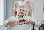 Portrait, heart or hand gesture with a senior man and his wife together in their home for love or health. Face, emoji and romance with a mature couple bonding in a house to relax during retirement