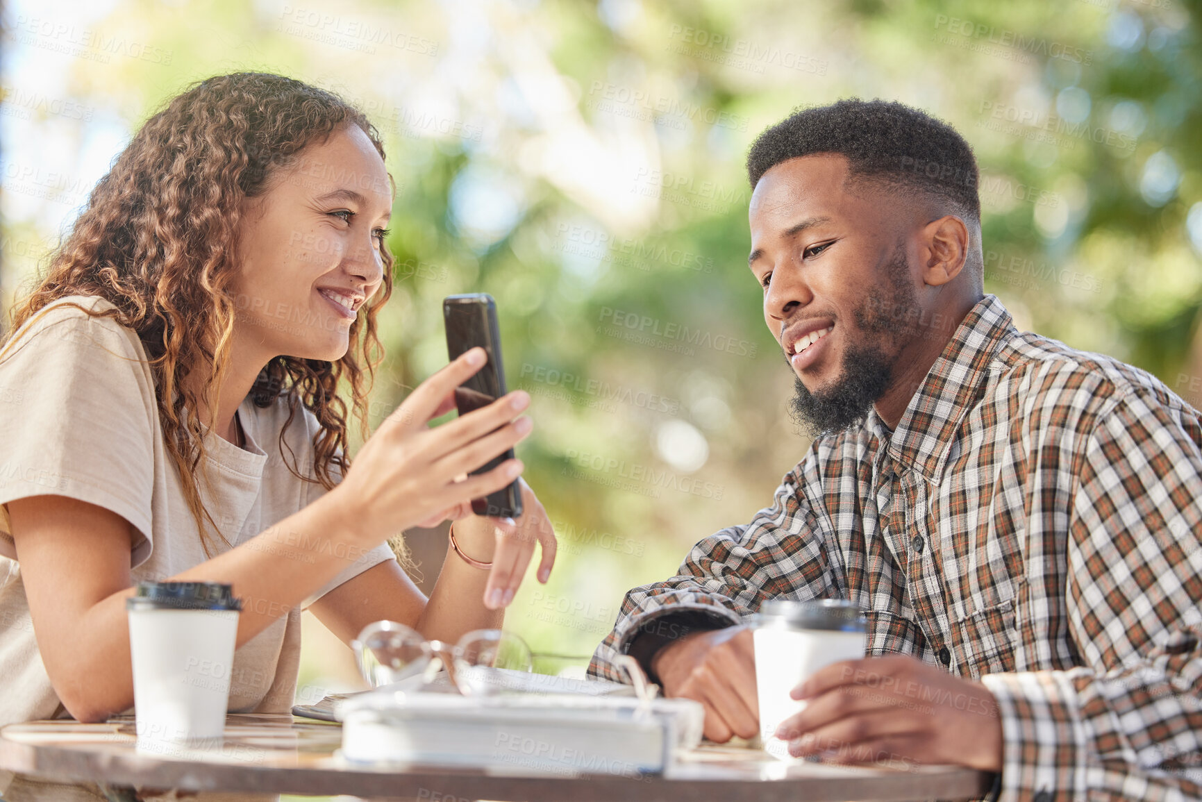 Buy stock photo Coffee, black couple and phone outdoor while talking and bonding on date at table. Man and woman at cafe with smartphone and a drink or tea to relax with mobile app, social media or online post