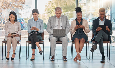 Buy stock photo Row, technology and business people waiting in an office for a meeting, interview or seminar. Diversity, working and employees sitting at work with tech for the recruitment process or a conference