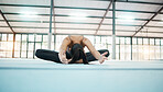 Gymnastics, stretching and sport woman in a gym for exercise and flexibility training. Lotus pose, wellness and pilates of a female gymnast on a sports mat for workout and fitness in health studio
