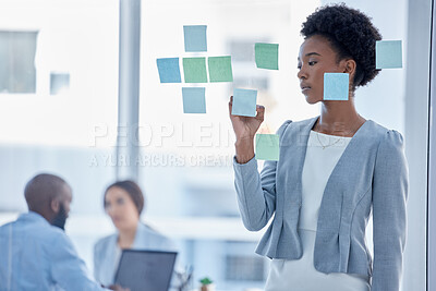 Buy stock photo Black woman, writing and schedule for team planning or brainstorming tasks on glass board at the office. Serious African American female working on project plan, with sticky note for strategy