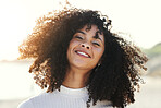 Black woman, smile and portrait at beach for vacation, freedom and face with natural hair and beauty. Happy young model person outdoor in nature for peace, travel and time to relax on sunset holiday