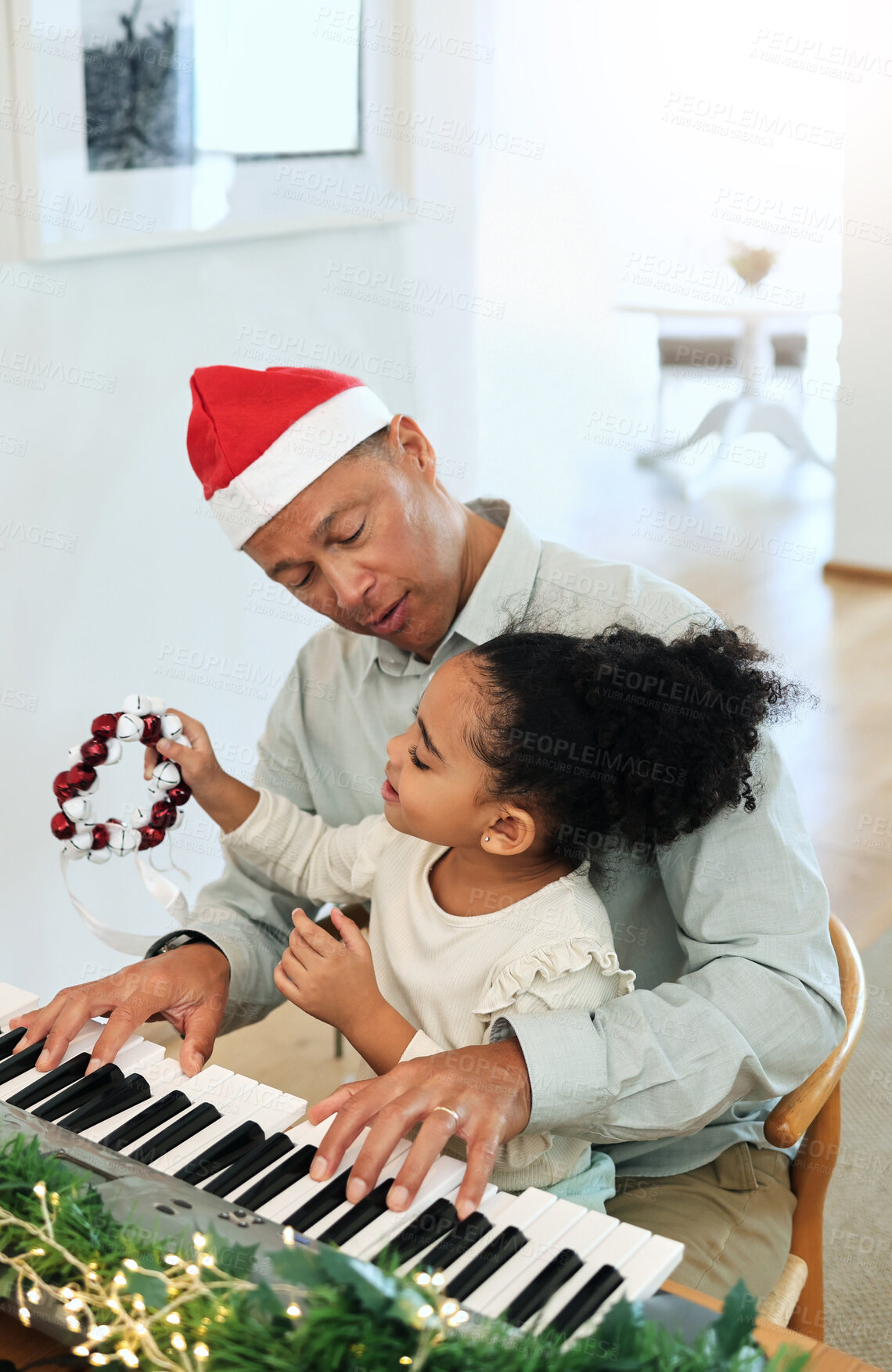 Buy stock photo Father, girl and teaching piano at Christmas with care, happiness or love with bonding, singing and house. Man, child and music keyboard for education, learning or holiday cheer in black family home